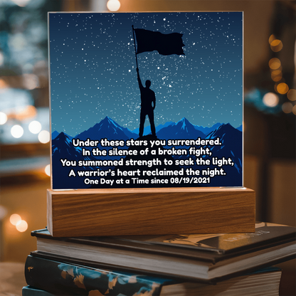 LED star map on wooden base with blue sky constellation lines, standing figure and flag