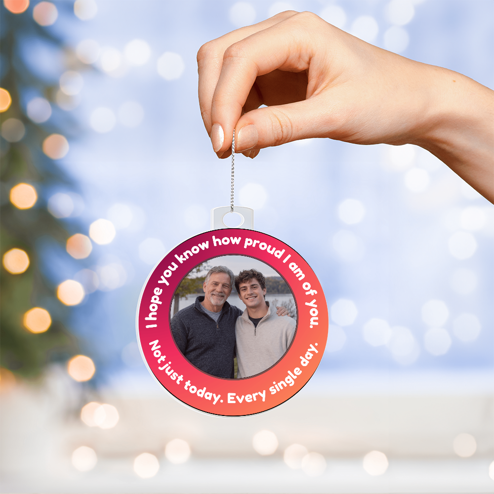 Acrylic ornament with circular red photo design, hung on a silver chain.