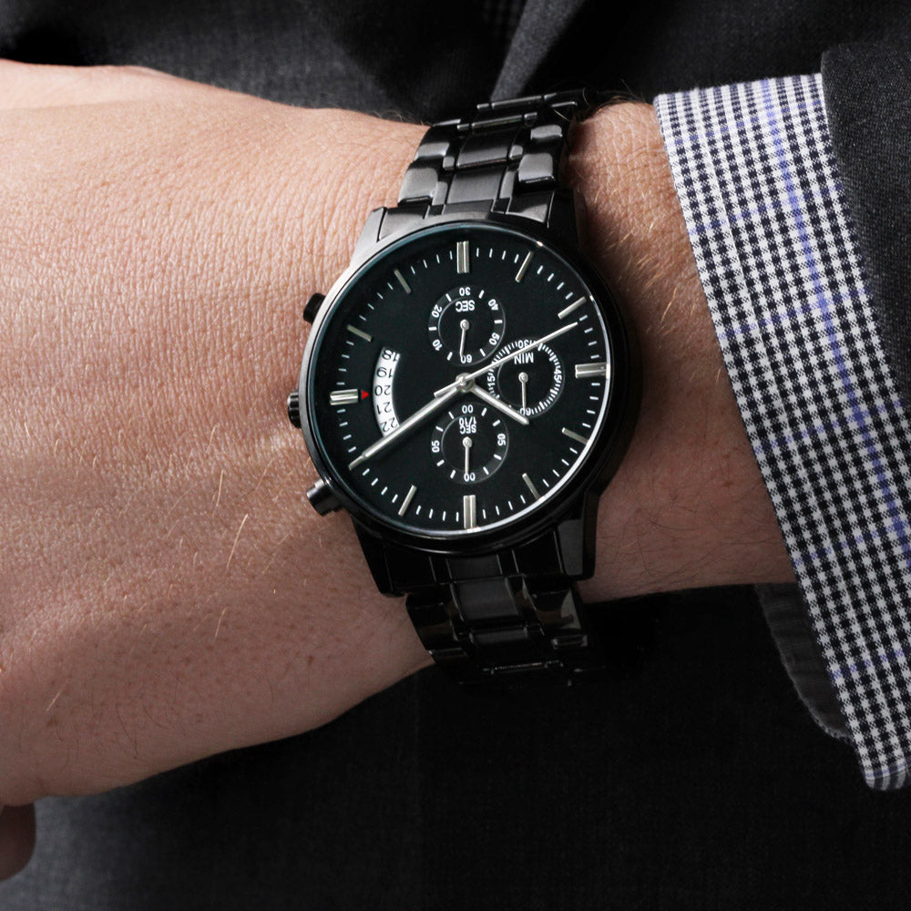 Black chronograph wristwatch with three subdials on a black metal link bracelet