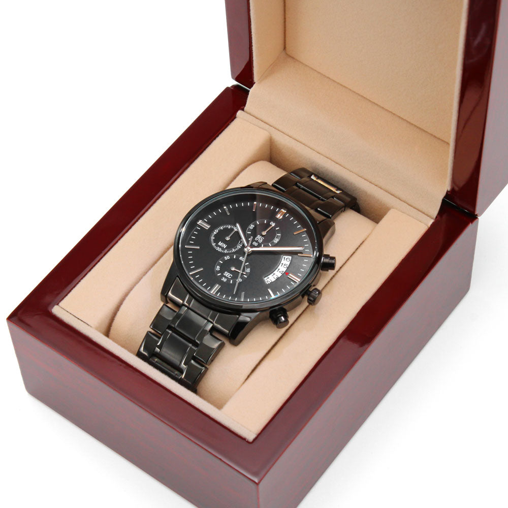 Black wristwatch in open display box with black metal bracelet