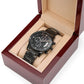 Black wristwatch in open display box with black metal bracelet