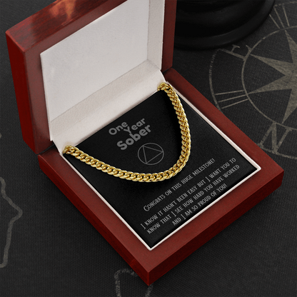 Gold Cuban link chain necklace on black gift card inside wooden box