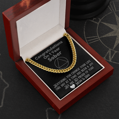 Gold Cuban link chain necklace in open gift box, draped over insert