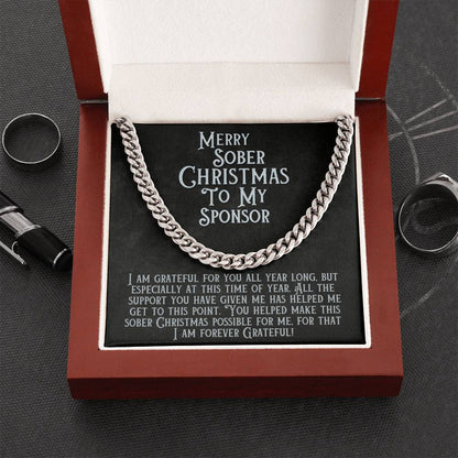 Silver-tone Cuban link chain necklace with message card reading “Merry Sober Christmas to My Sponsor”.