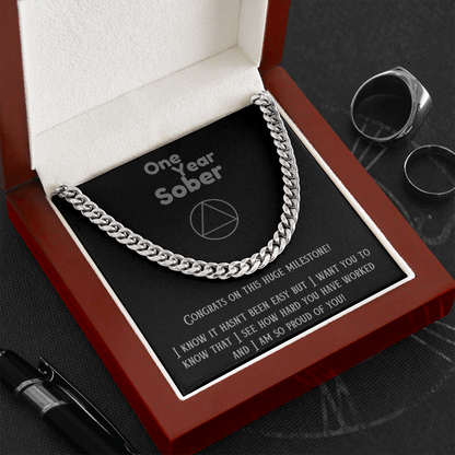 Silver Cuban link chain necklace on black gift card in open box