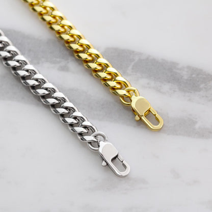 Cuban link chain necklaces closeup with spring-ring clasps, silver and gold tones
