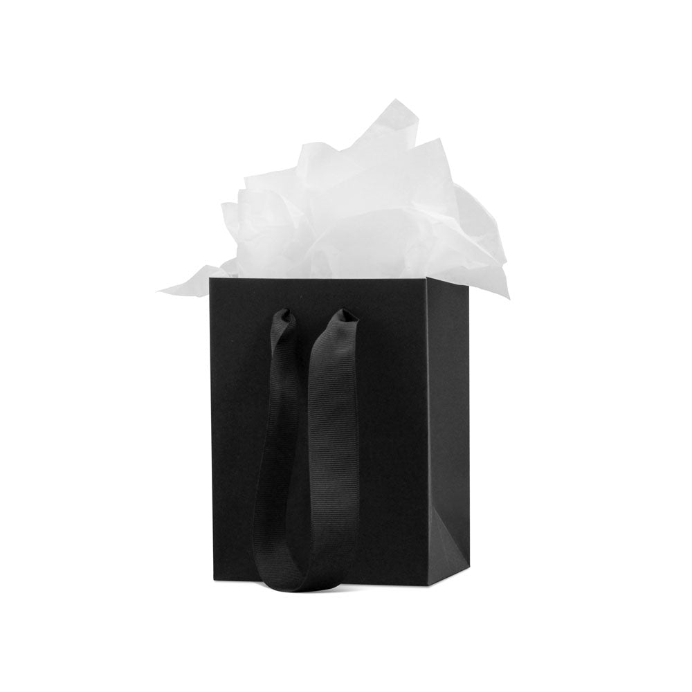 Gift bag with tissue paper wrap and black ribbon handles