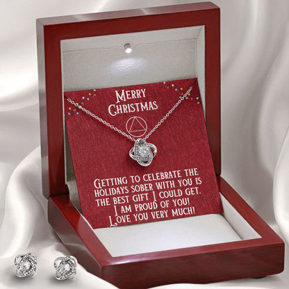 Open luxury-style gift box with heart pendant necklace and stud earrings