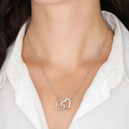 Two-tone heart necklace pendant on a silver chain worn on the neckline