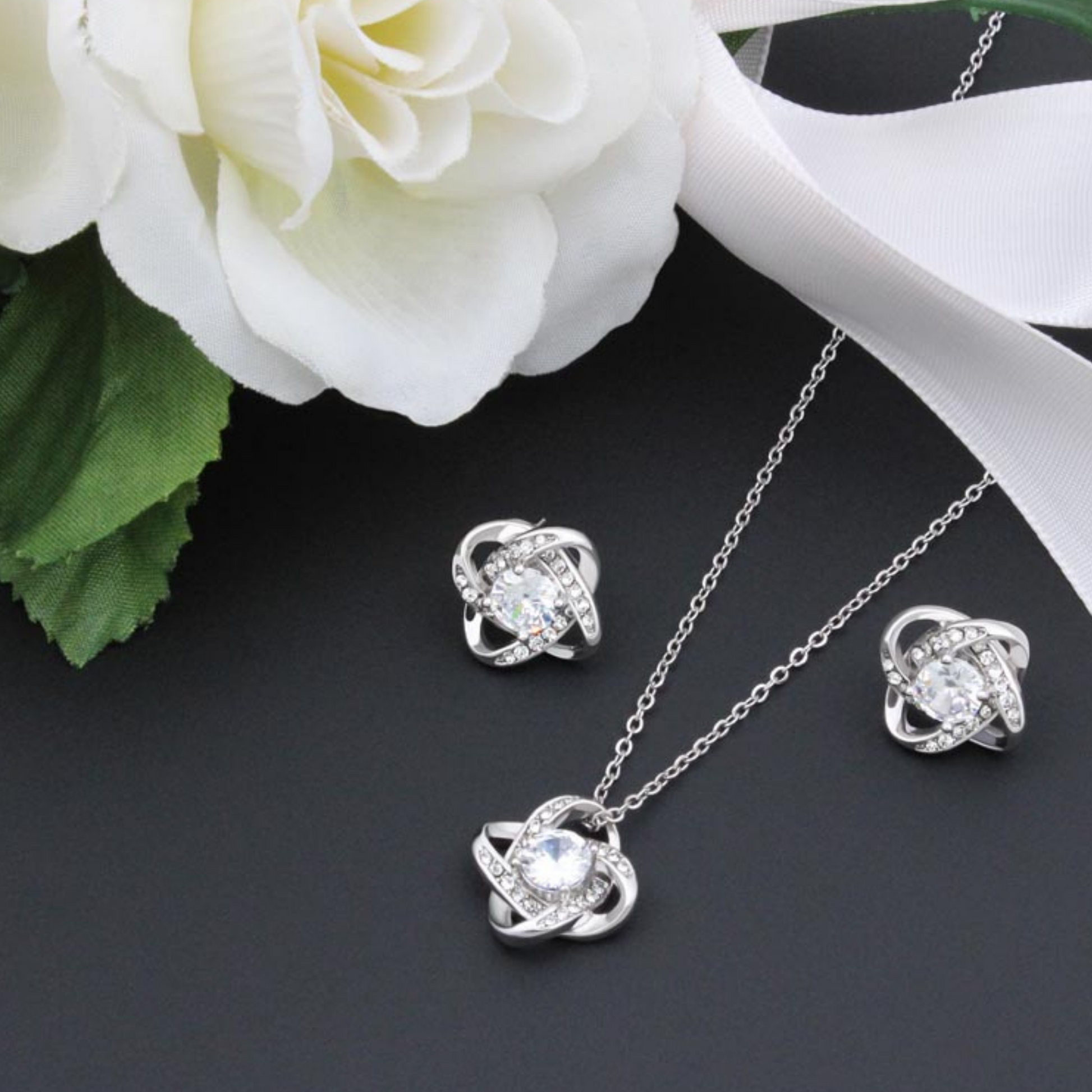 Cubic zirconia knot stud earrings, round center stones in twisted knot frames
