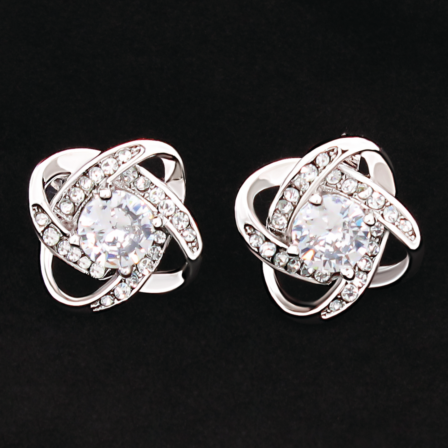 Silver-tone cubic zirconia knot stud earrings, clear round stones with faceted halos