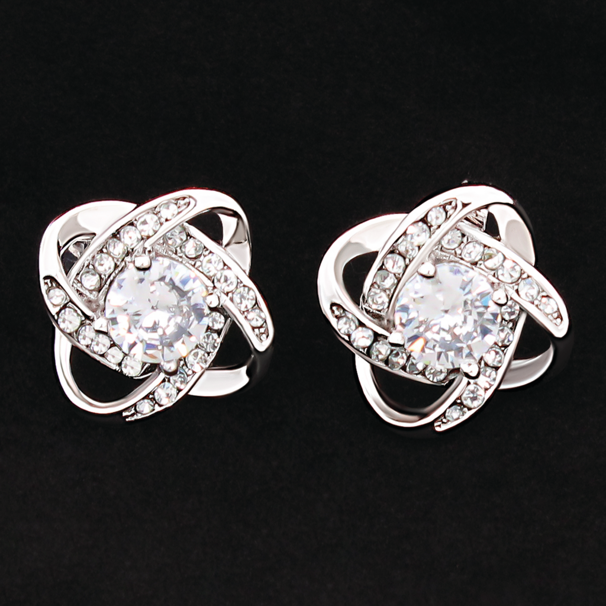 Silver-tone cubic zirconia knot stud earrings, clear round stones with faceted halos